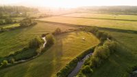 AdobeStock – Aerial Oxbow Lake & Farmland A variety or produce in baskets