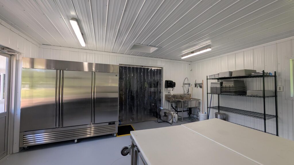 Commercial Cut Room For Poultry. Stainless Steel appliances in a large commercial-grade kitchen.