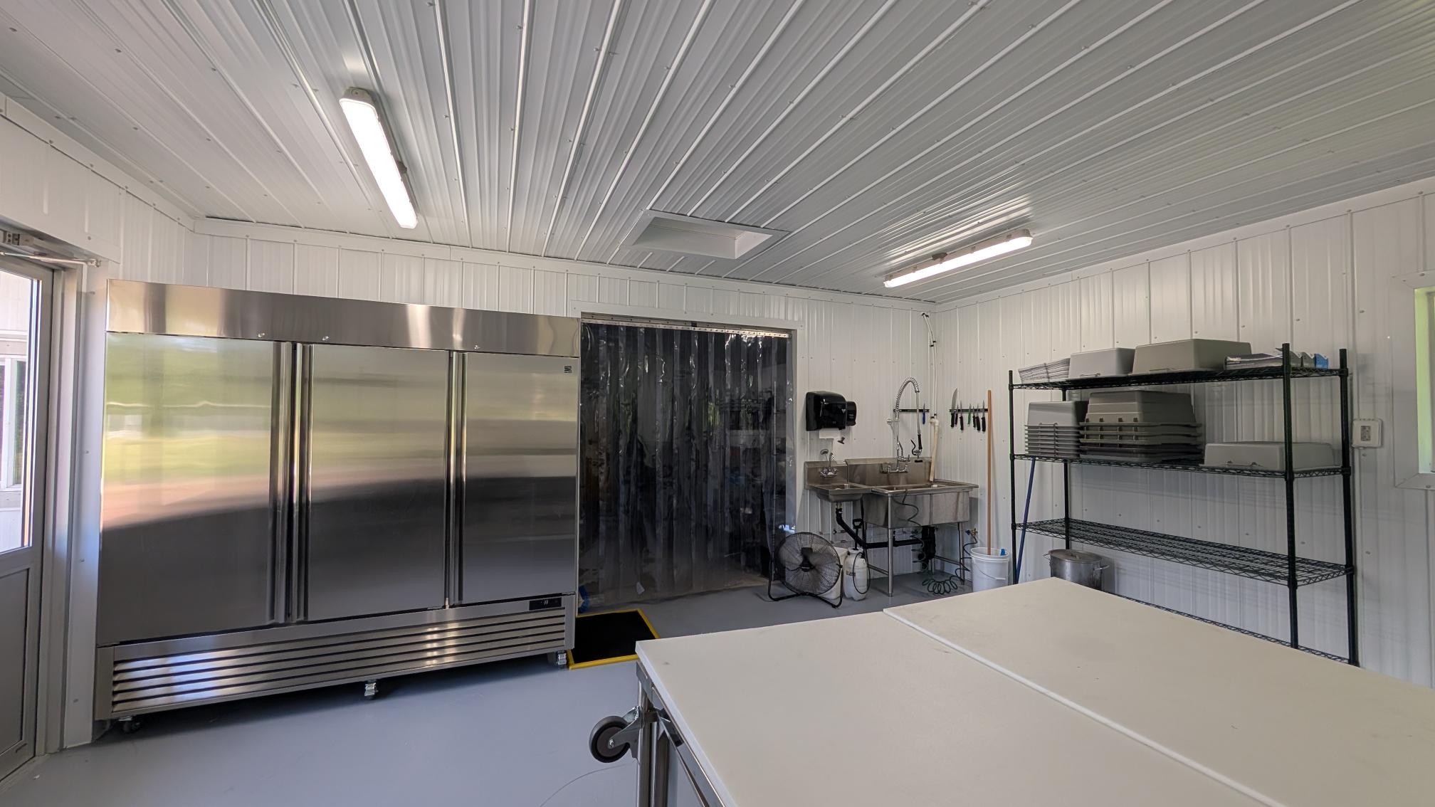 Commercial Cut Room For Poultry. Stainless Steel appliances in a large commercial-grade kitchen.